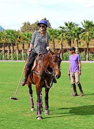 four riders on a polo field with two instructors
